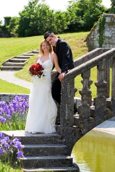 A bride and groom standing outside portrait