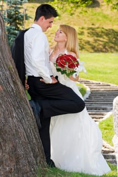 A bride and groom standing outside portrait