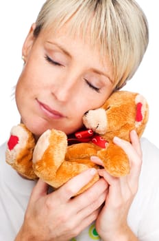 young blond girl with tedy bear close up