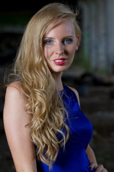 Portrait of woman in blue cocktail dress outdoor