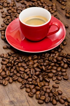 Arabica beans and red espresso cup in portrait format