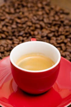 Close-up espresso in red cup and Arabica beans