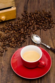 Espresso coffee in a red cup and coffee beans