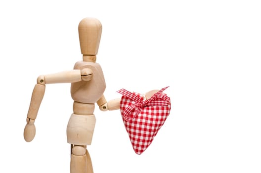Male figure made of wood holds a red checkered heart