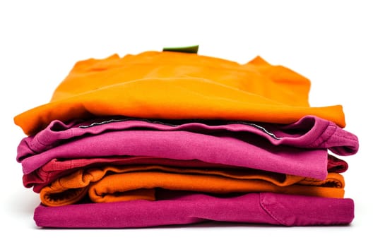 Stack of colored clothes against a white background