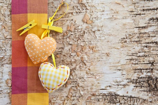 Birch bark background with yellow-toed hearts