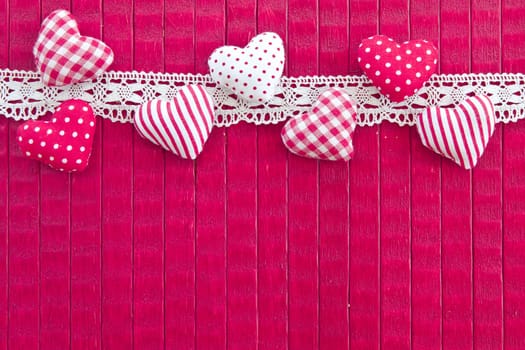 Pink background with small hearts and lace border