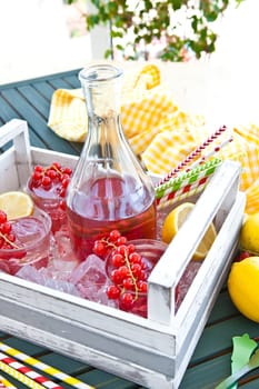 Homemade lemonade with currants and fresh lemons