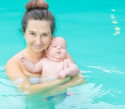 Baby and mom in swimming pool