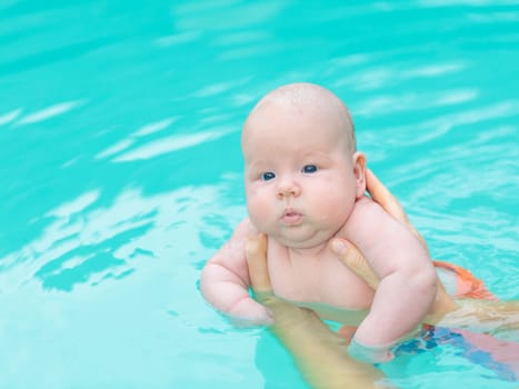 Adorable baby in swimming pool