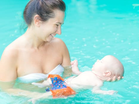 Baby and mom in swimming pool