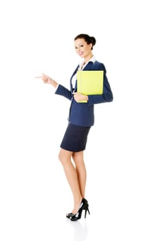 Happy young success business woman pointing on copy space, isolated on white