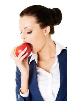 Attractive smiling businesswoman holding red apple, isolated on white