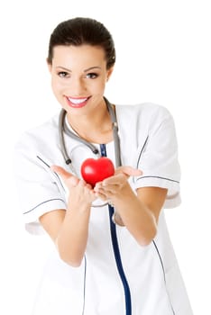 Young nurse with heart in her hand , isolated on white.