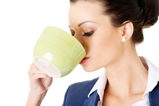 Businesswoman having coffee / tea break isolated on white background