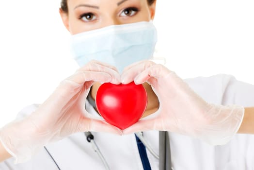 Young nurse with heart in her hand , isolated on white.