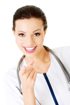 Female doctor pointing at the screen, isolated on white