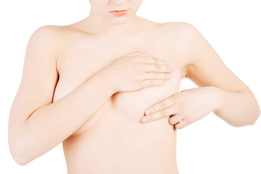 Caucasian adult woman examining her breast for lumps or signs of breast cancer
