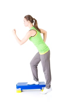 Fitness girl is working out with stepper , isolated on white background