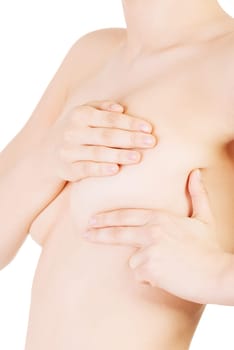 Caucasian adult woman examining her breast for lumps or signs of breast cancer