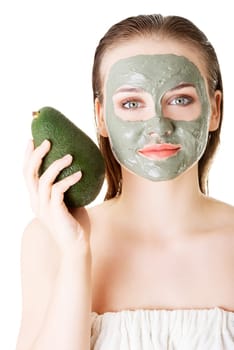 Beautiful woman with green avocado clay facial mask, isolated on white
