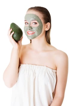 Beautiful woman with green avocado clay facial mask, isolated on white