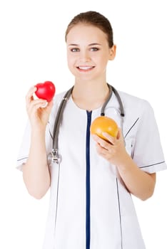 Female doctor holding healthy grapefruit and red heart. Isolated on white.