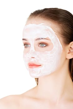 Beautiful woman with clay facial mask, isolated on white