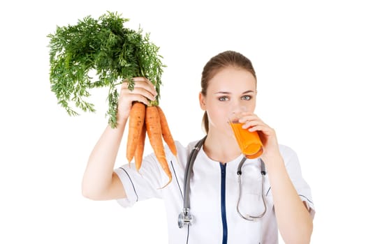 Female doctor holding healthy carrots and juice. Isolated on white.