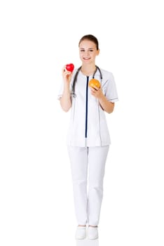 Female doctor holding healthy grapefruit and red heart. Isolated on white.