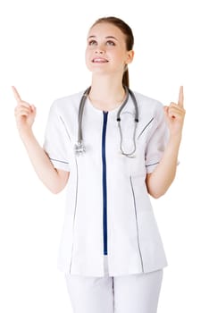 Woman doctor or nurse pointing on copy space. Isolated on white