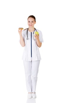 Dietician holding sweet doughnut and fresh healthy green apple. Isolated on white
