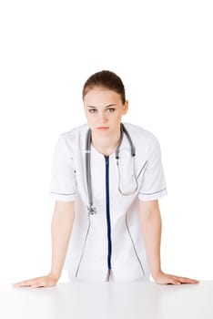 Medical doctor or nurse behind the desk. Isolated over white background