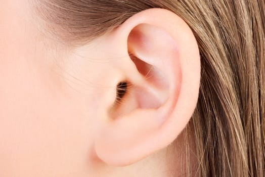 Young caucasian woman ear closeup.