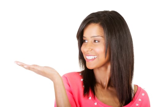 Happy , excited young woman presenting copy space on her palm, isolated on white