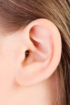 Young caucasian woman ear closeup.