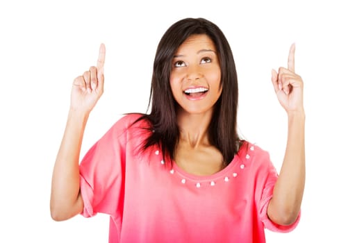 Happy , excited young woman pointing on copy space, isolated on white