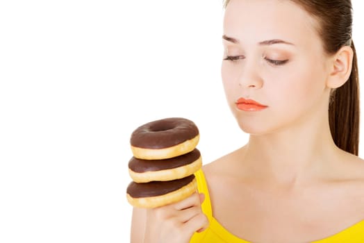 Woman with a pile of doughnuts. Isolated on white.
