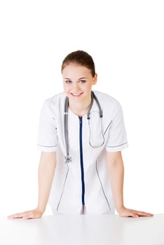 Medical doctor or nurse behind the desk. Isolated over white background