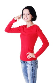 Young happy woman gesturing "call me"" , isolated on white"