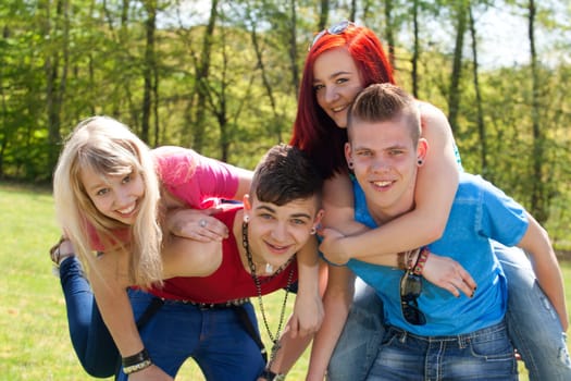 Young teenage group with colored shirts are having fun