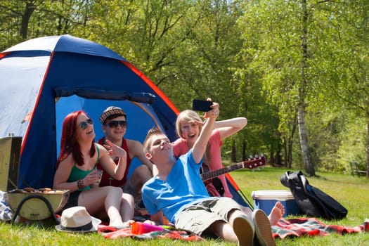 Young teeanger group are making the picture with a phone camera
