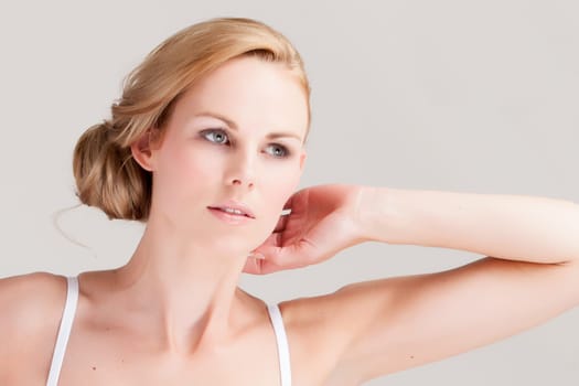 Beautifull young blond woman in the studio is relaxing