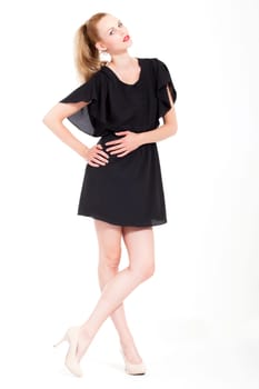 Beautifull young blond woman in the studio with a sexy black dress
