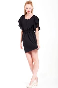 Beautifull young blond woman in the studio with a sexy black dress
