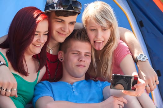 Young teeanger group are making the picture with a phone camera