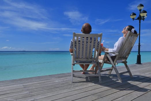 happy young couple relax and take fresh drink at summer vacation