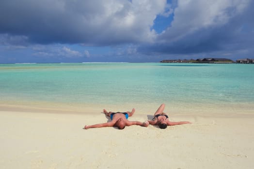 happy young couple have fun and relax at summer vacation on background maldives travel location and beautiful white sand beach