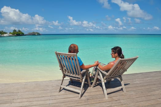 happy young couple have fun and relax at summer vacation on background maldives travel location and beautiful white sand beach