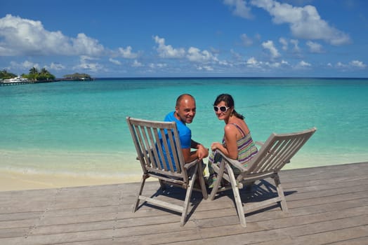 happy young couple have fun and relax at summer vacation on background maldives travel location and beautiful white sand beach